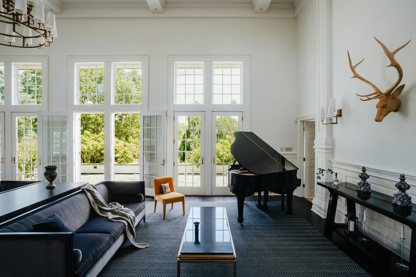 a living room filled with furniture and a grand piano